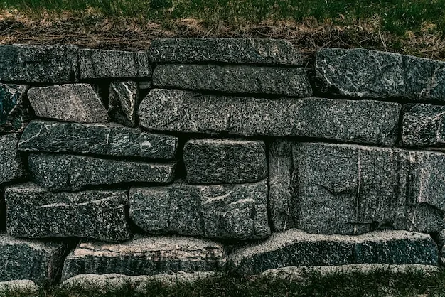 Coursed natural stone retaining wall in a country garden setting